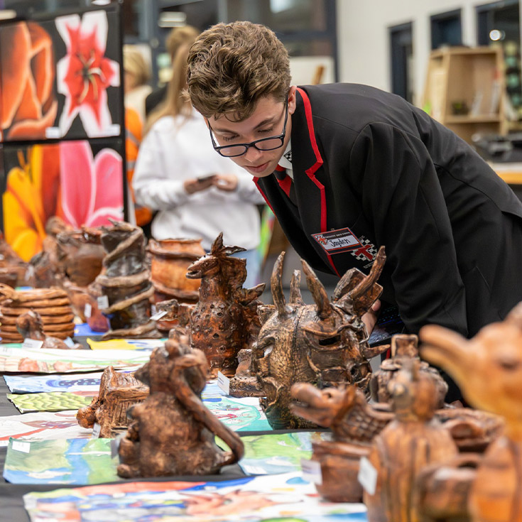 Student at an art exhibition at Xavier College Llandilo